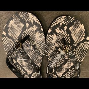 Tory Burch snakeskin flip flops. NWOT but still have the plastic band connector.